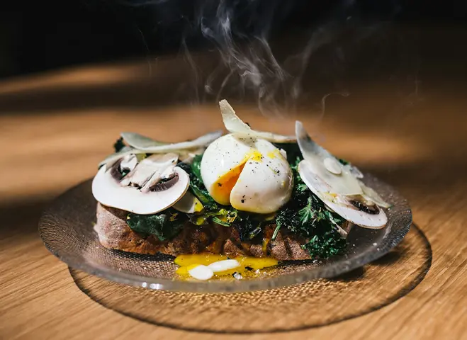 Plate of food with mushrooms on top